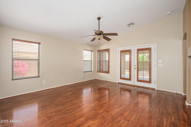 spare room with ceiling fan, plenty of natural light, and wood finished floors