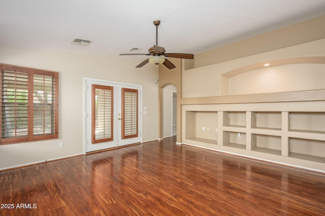 unfurnished living room with ceiling fan, french doors, wood finished floors, vaulted ceiling, and visible vents