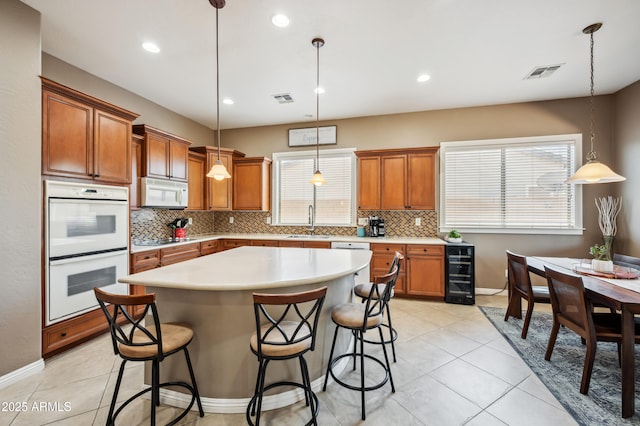 8417 W Northview Ave, Glendale, AZ 85305 - kitchen with white appliances, a sink, brown cabinetry, backsplash, and wine cooler