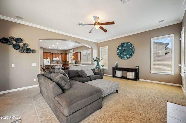 8417 W Northview Ave, Glendale, AZ 85305 - living area with baseboards, a ceiling fan, healthy amount of natural light, arched walkways, and crown molding