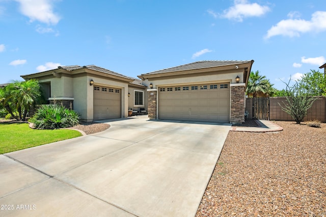 8417 W Northview Ave, Glendale, AZ 85305 - prairie-style home featuring stucco siding, a garage, driveway, and stone siding