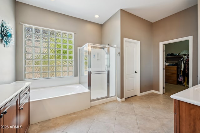 8417 W Northview Ave, Glendale, AZ 85305 - full bath with vanity, a shower stall, a bath, tile patterned floors, and a spacious closet