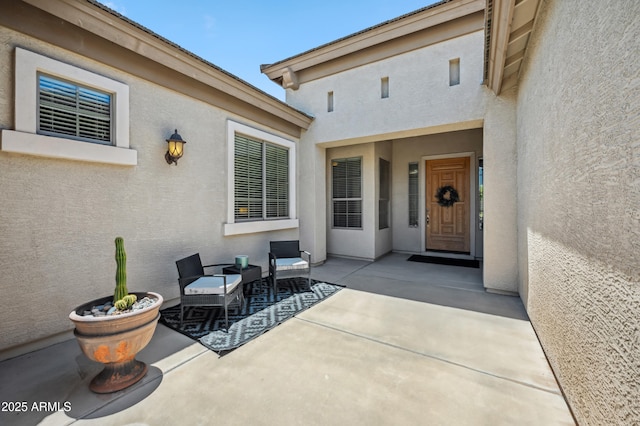 8417 W Northview Ave, Glendale, AZ 85305 - view of exterior entry featuring stucco siding and a patio area