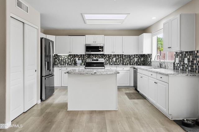 3126 W Stephens Pl, Chandler, AZ 85226 - kitchen featuring appliances with stainless steel finishes, a sink, white cabinetry, light wood-style floors, and recessed lighting