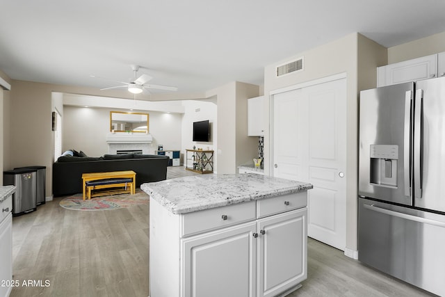 3126 W Stephens Pl, Chandler, AZ 85226 - kitchen featuring stainless steel fridge, a ceiling fan, light wood-type flooring, and white cabinets