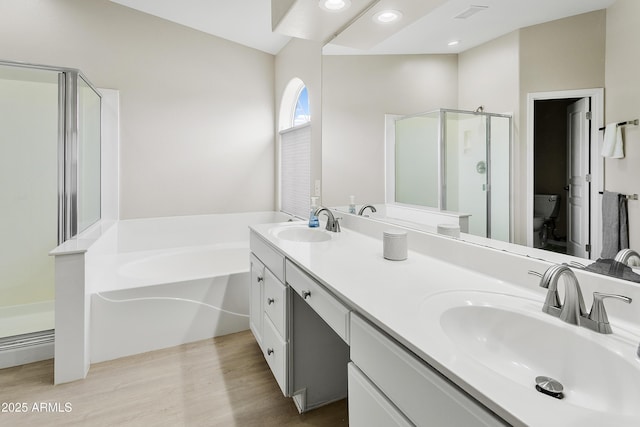 3126 W Stephens Pl, Chandler, AZ 85226 - bathroom with a stall shower, double vanity, a garden tub, toilet, and wood finished floors