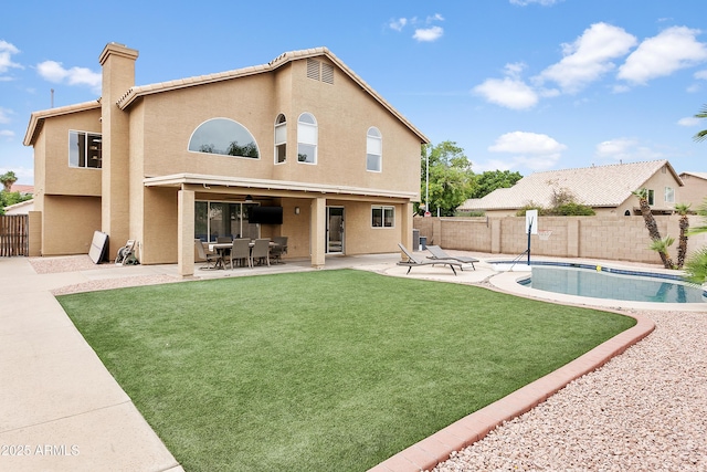 3126 W Stephens Pl, Chandler, AZ 85226 - back of property featuring a patio area, stucco siding, a chimney, and a ceiling fan