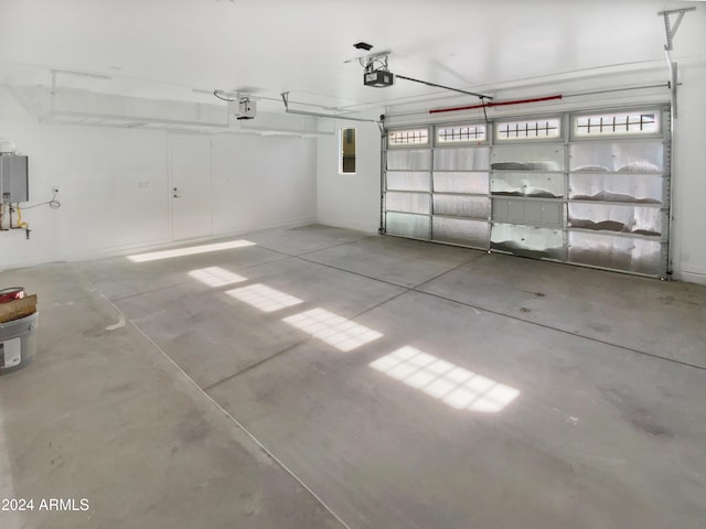 garage featuring a garage door opener and water heater