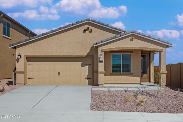 10341 N 115th Ave, Youngtown, AZ 85363 - view of front facade featuring driveway, fence, a garage, a tile roof, and stucco siding