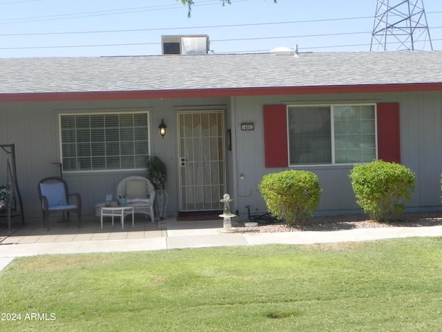 doorway to property with a lawn