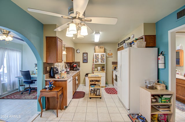 kitchen featuring sink, ceiling fan, light tile patterned floors, white appliances, and tasteful backsplash