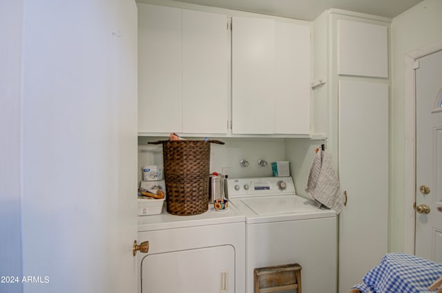 laundry area featuring cabinets and washer and clothes dryer