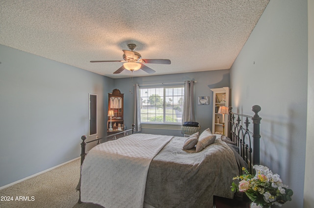 bedroom featuring ceiling fan, carpet, and a textured ceiling