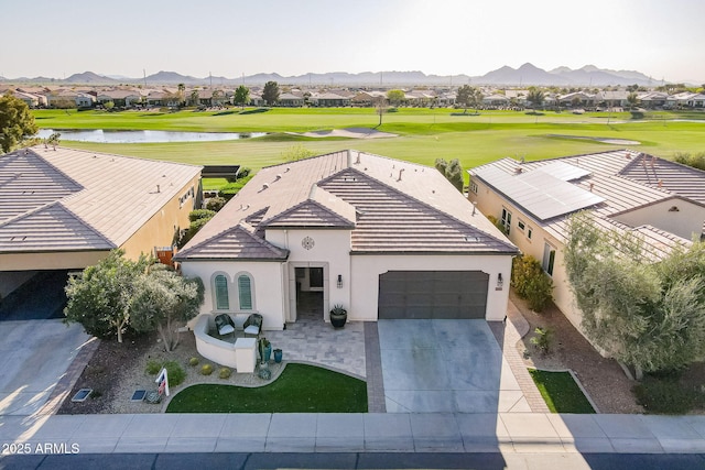 drone / aerial view featuring a residential view, a water and mountain view, and view of golf course