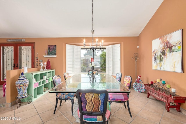 dining room featuring lofted ceiling, a notable chandelier, light tile patterned floors, and french doors