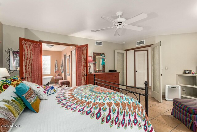 bedroom with light tile patterned floors, visible vents, and a ceiling fan