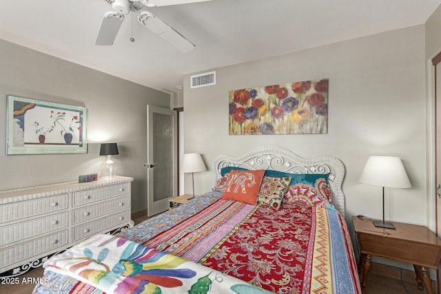 tiled bedroom featuring a ceiling fan and visible vents