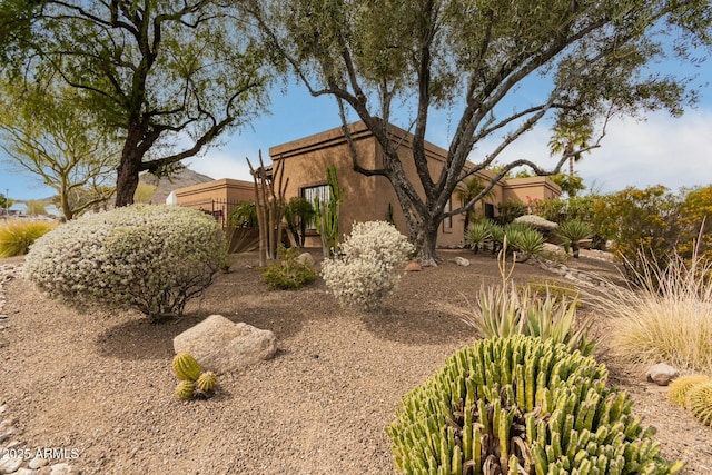 view of side of property with stucco siding