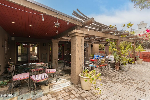 view of patio with outdoor dining space and a pergola