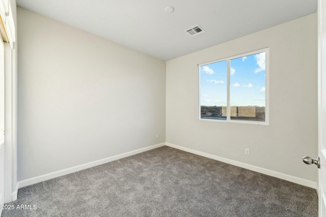 unfurnished room featuring carpet, visible vents, and baseboards