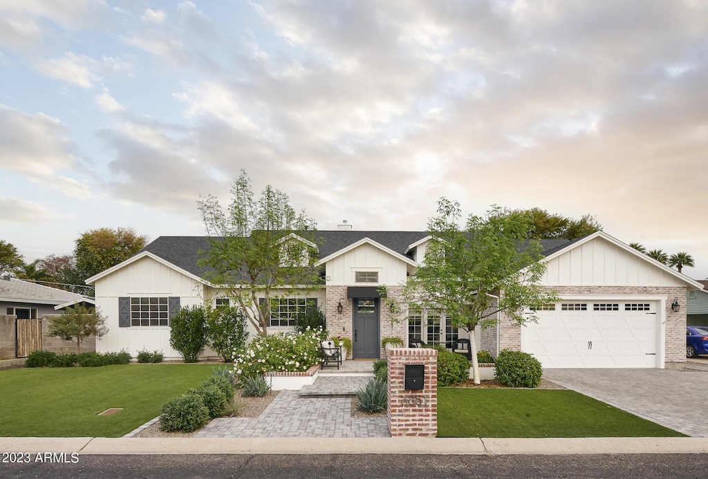 view of front of house with a garage and a front lawn