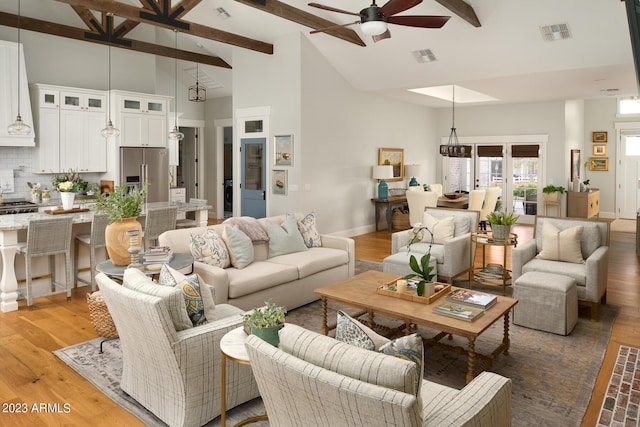 living room featuring beam ceiling, high vaulted ceiling, ceiling fan, and hardwood / wood-style flooring