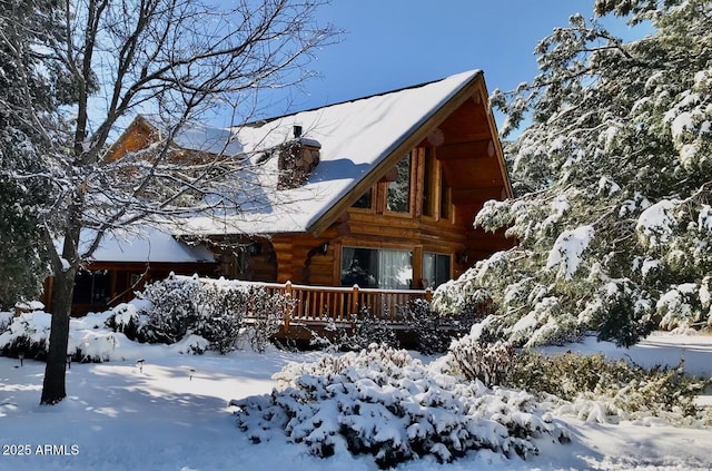 6168 W Hidden Pines Loop, Pine, AZ 85544 - view of front of house featuring log siding, a wooden deck, and a chimney