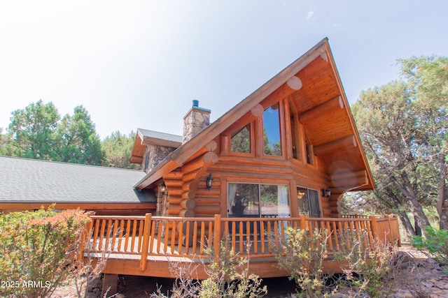 6168 W Hidden Pines Loop, Pine, AZ 85544 - rear view of house featuring log siding, a chimney, and a deck