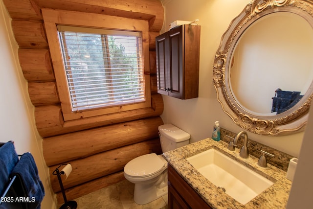 6168 W Hidden Pines Loop, Pine, AZ 85544 - bathroom featuring rustic walls, vanity, and toilet