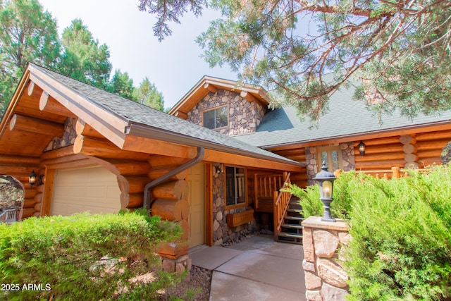 6168 W Hidden Pines Loop, Pine, AZ 85544 - view of front of property featuring stone siding, log exterior, and a garage