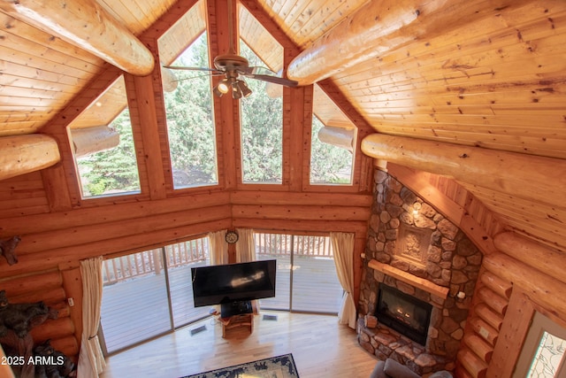 6168 W Hidden Pines Loop, Pine, AZ 85544 - unfurnished living room with wood finished floors, wooden ceiling with exposed beams, high vaulted ceiling, a fireplace, and healthy amount of natural light