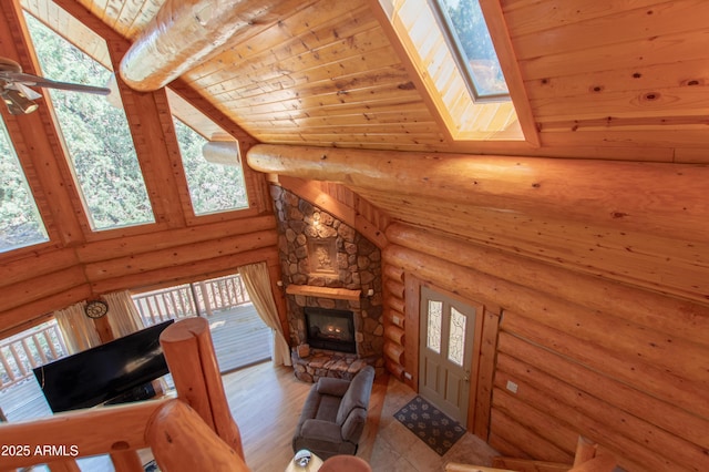 6168 W Hidden Pines Loop, Pine, AZ 85544 - unfurnished living room featuring wood ceiling, a towering ceiling, a fireplace, a skylight, and wood finished floors