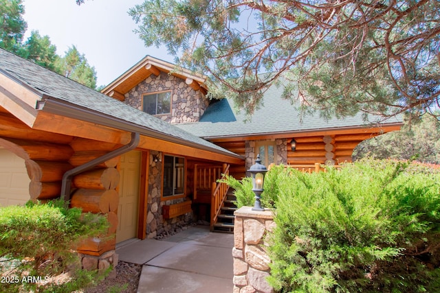 6168 W Hidden Pines Loop, Pine, AZ 85544 - view of side of home featuring stone siding, a shingled roof, and log exterior