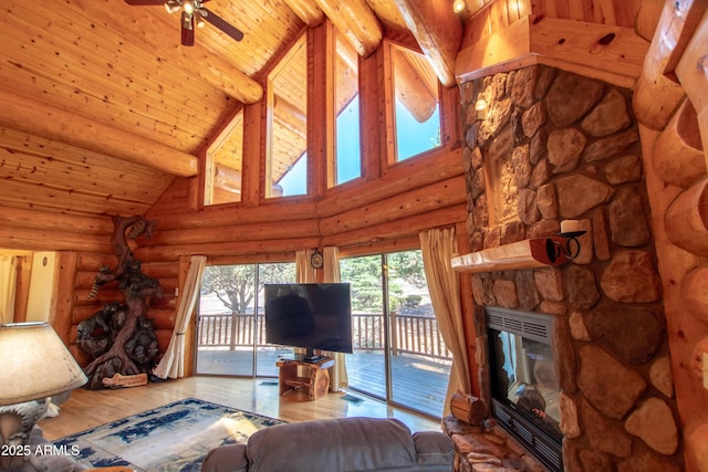 6168 W Hidden Pines Loop, Pine, AZ 85544 - living room featuring high vaulted ceiling, a fireplace, wood finished floors, a ceiling fan, and log walls