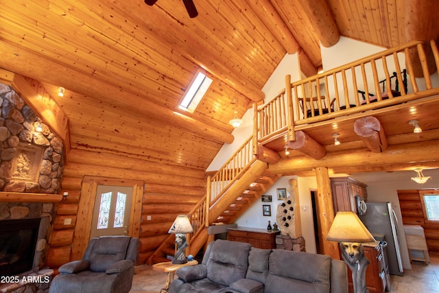 6168 W Hidden Pines Loop, Pine, AZ 85544 - living room with stairway, high vaulted ceiling, wooden ceiling with exposed beams, a stone fireplace, and ceiling fan