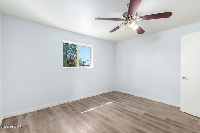 empty room with light hardwood / wood-style flooring and ceiling fan