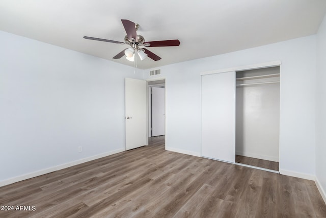 unfurnished bedroom featuring a closet, ceiling fan, and hardwood / wood-style flooring