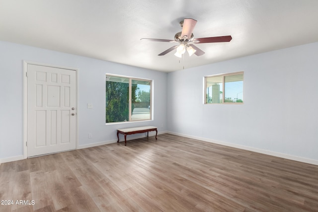 empty room with light wood-type flooring and ceiling fan