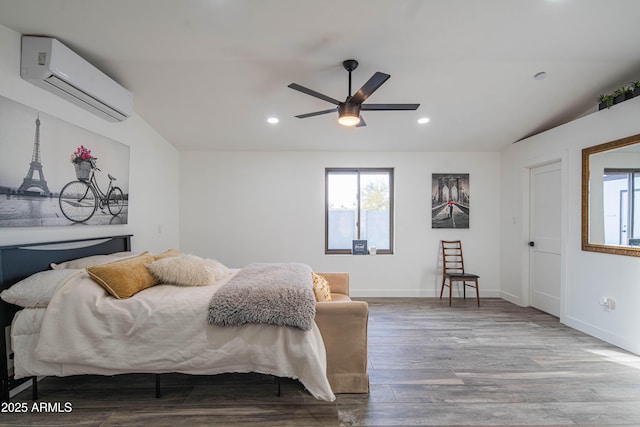 bedroom with ceiling fan, an AC wall unit, and hardwood / wood-style flooring