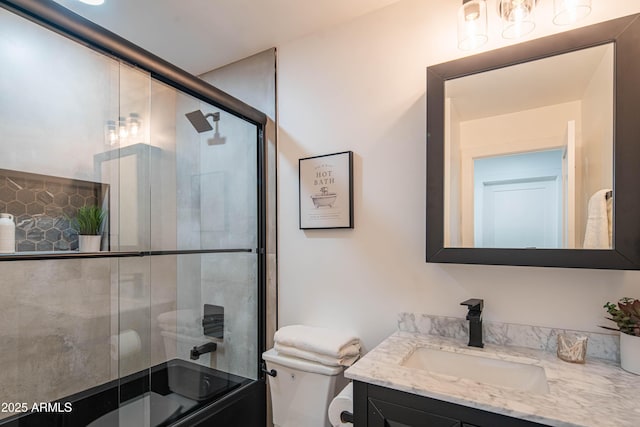 full bathroom with toilet, vanity, and combined bath / shower with glass door