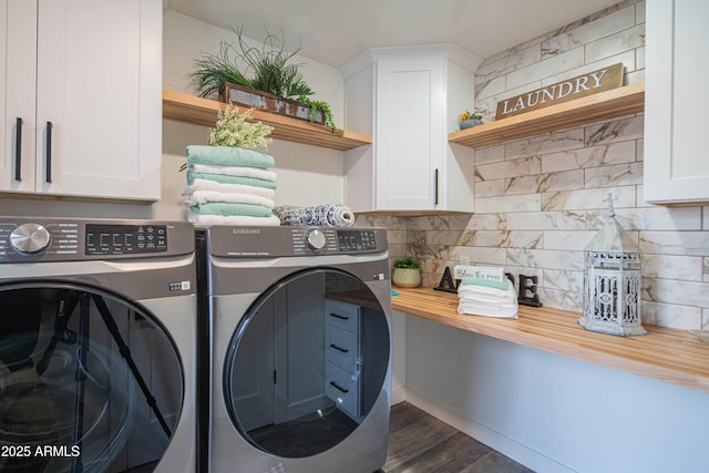 washroom featuring separate washer and dryer, cabinets, and dark wood-type flooring