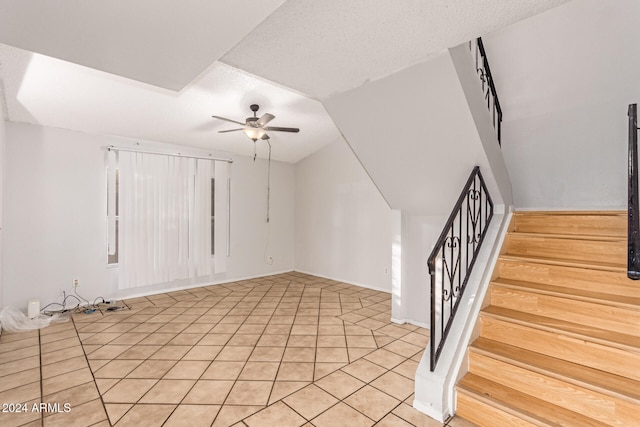 interior space featuring ceiling fan and a textured ceiling