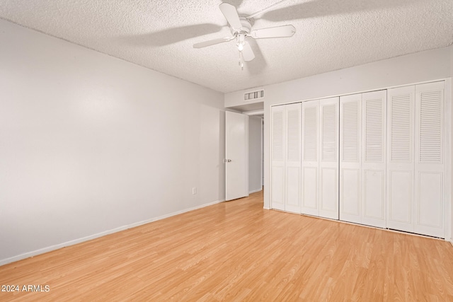 unfurnished bedroom featuring light hardwood / wood-style floors, a textured ceiling, and ceiling fan