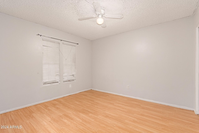 empty room featuring ceiling fan, a textured ceiling, and light hardwood / wood-style flooring