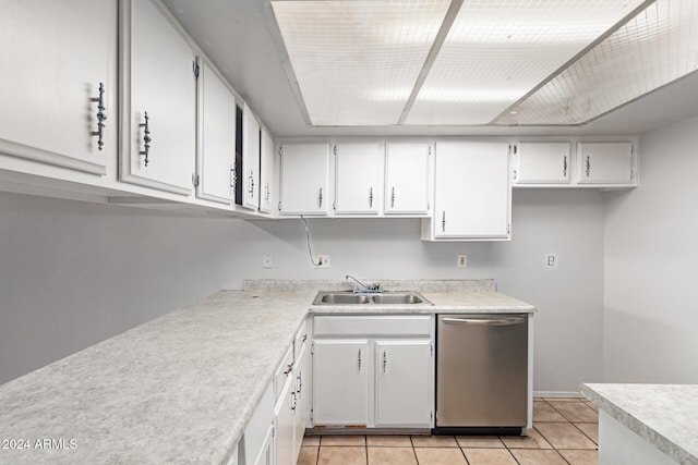 kitchen featuring light tile patterned floors, sink, white cabinetry, and stainless steel dishwasher