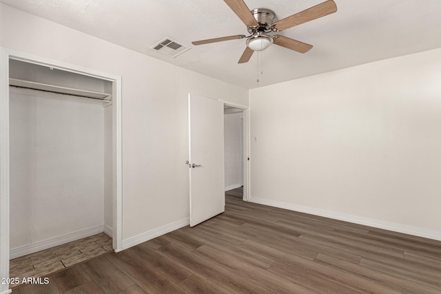 1113 E 5th St, Casa Grande, AZ 85122 - unfurnished bedroom with wood finished floors, a closet, and ceiling fan