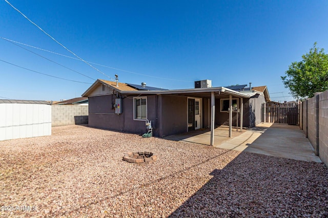 1113 E 5th St, Casa Grande, AZ 85122 - back of property featuring a fenced backyard, roof mounted solar panels, and a patio