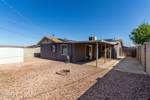 1113 E 5th St, Casa Grande, AZ 85122 - back of property with a fenced backyard, roof mounted solar panels, and a patio