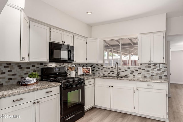 1113 E 5th St, Casa Grande, AZ 85122 - kitchen featuring black appliances, white cabinets, decorative backsplash, light stone countertops, and recessed lighting