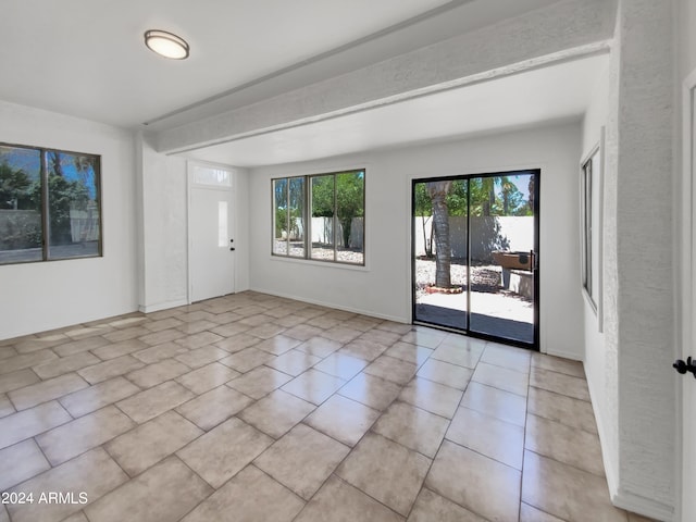 unfurnished room featuring light tile floors